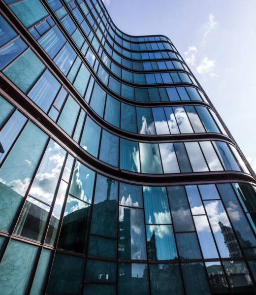 high-rise-building-glass-facade-with-reflection-surrounding-buildings